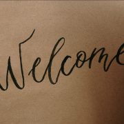A large "welcome" written by hand
